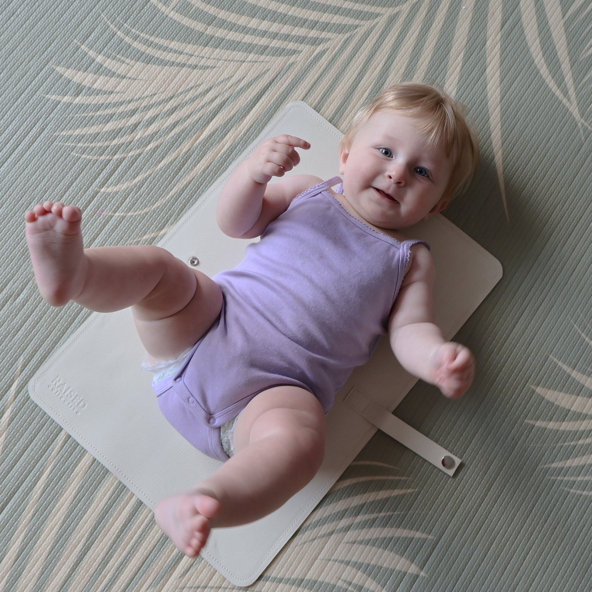 Baby change mat in off white, minimal branding, easy to transport and wipe clean