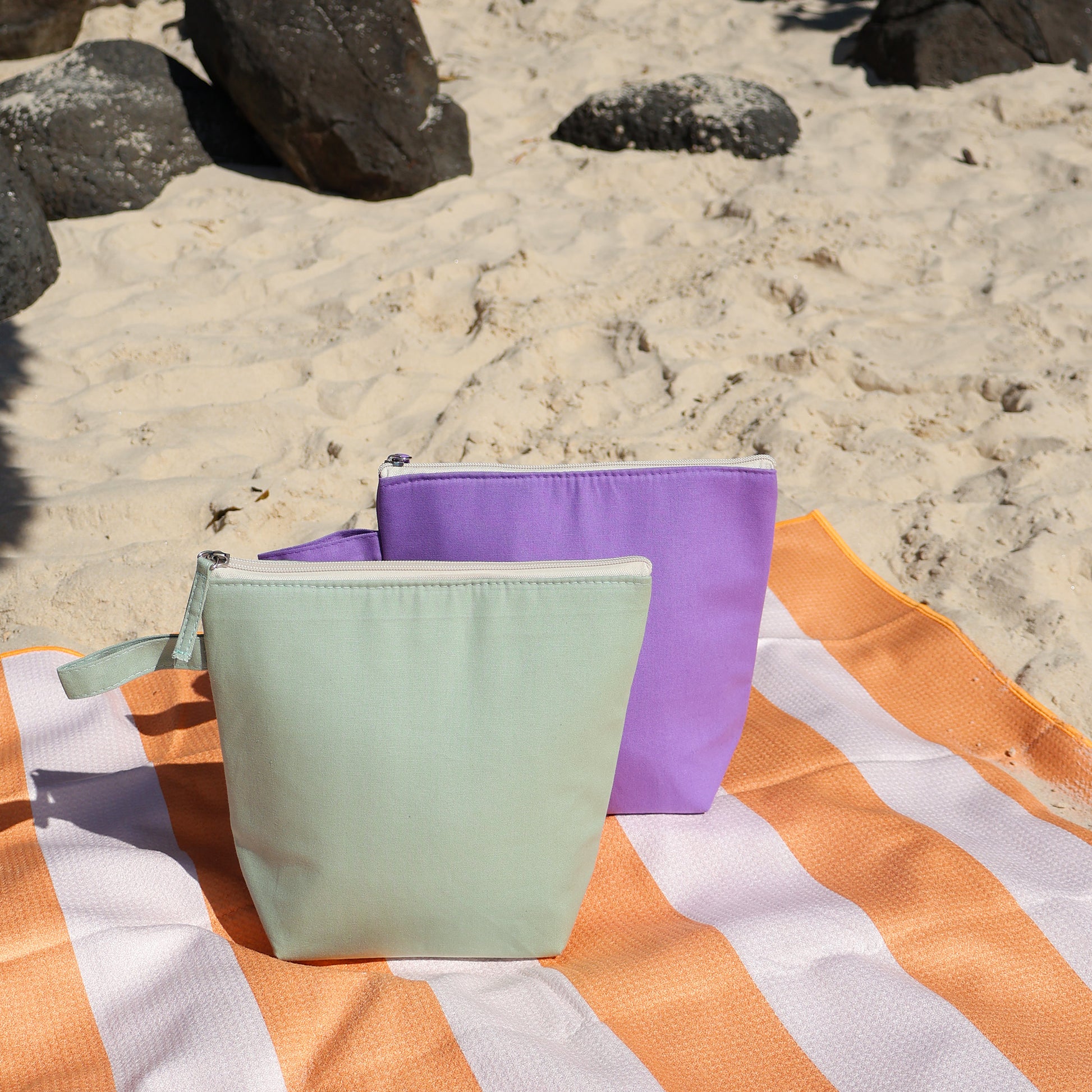 Cooler pods at the beach in action seen here on our Amalfi Sand Free beach towel in orange stripe.  Cute little accessory for your beach or park trip with the kids!