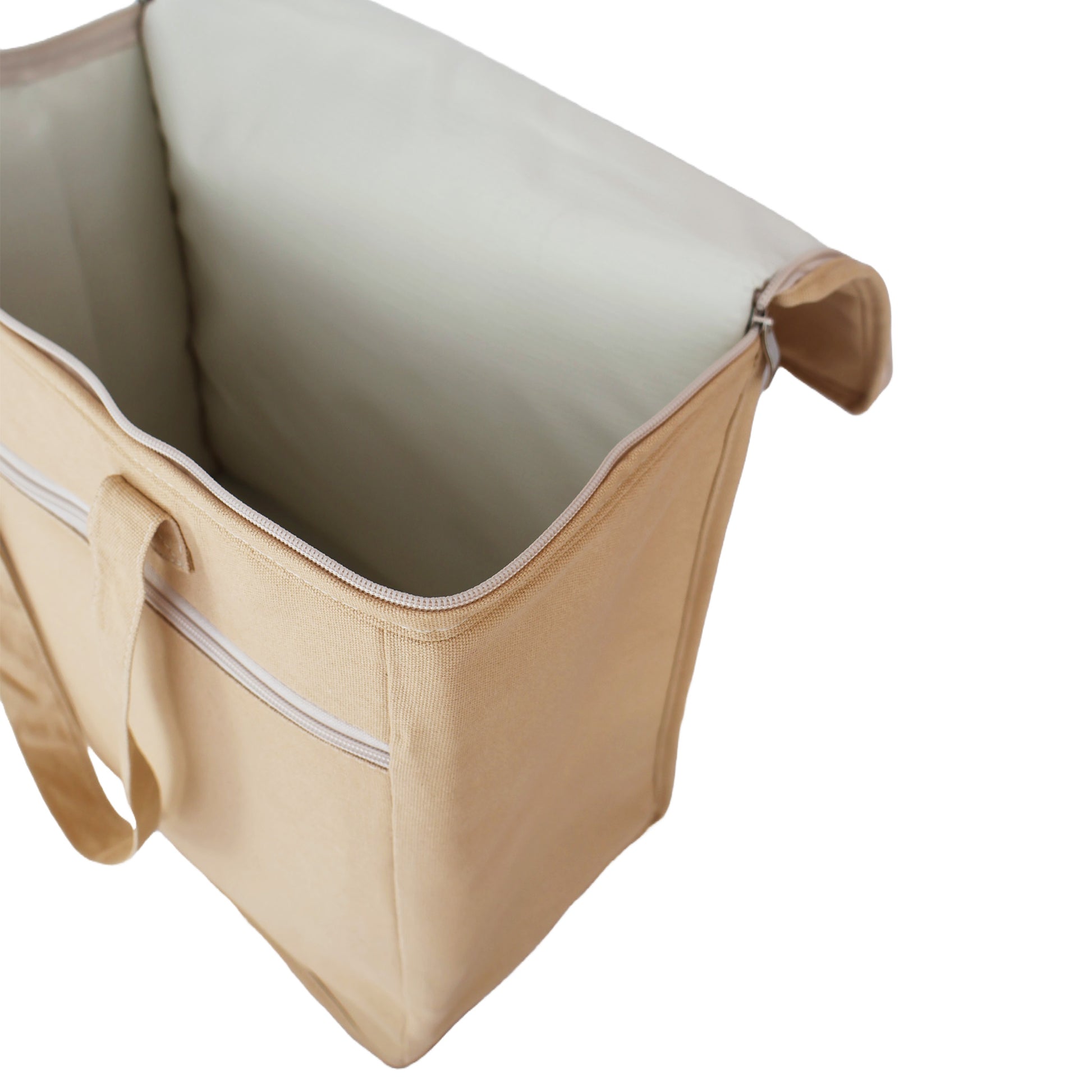 Inside view of the picnic cooler bag in sand, made from cotton canvas, large main insulated compartment and smaller front zippered compartment for keys, wallet and phone.  For beach and picnic days, buy well and buy once.